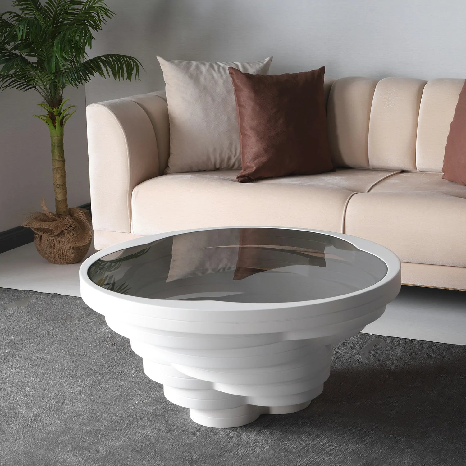 Black sculptural round coffee table with layered vortex base
