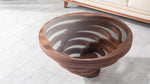 Layered wooden coffee table with glass surface and depth
