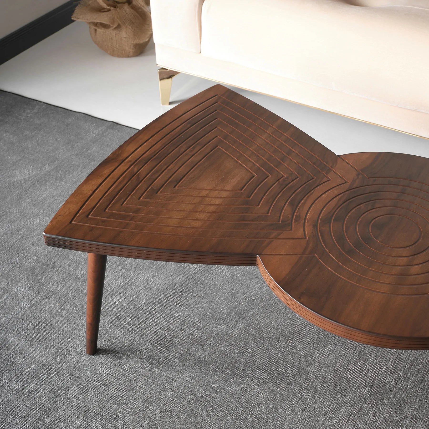 Asymmetrical modern centerpiece table with carved accents