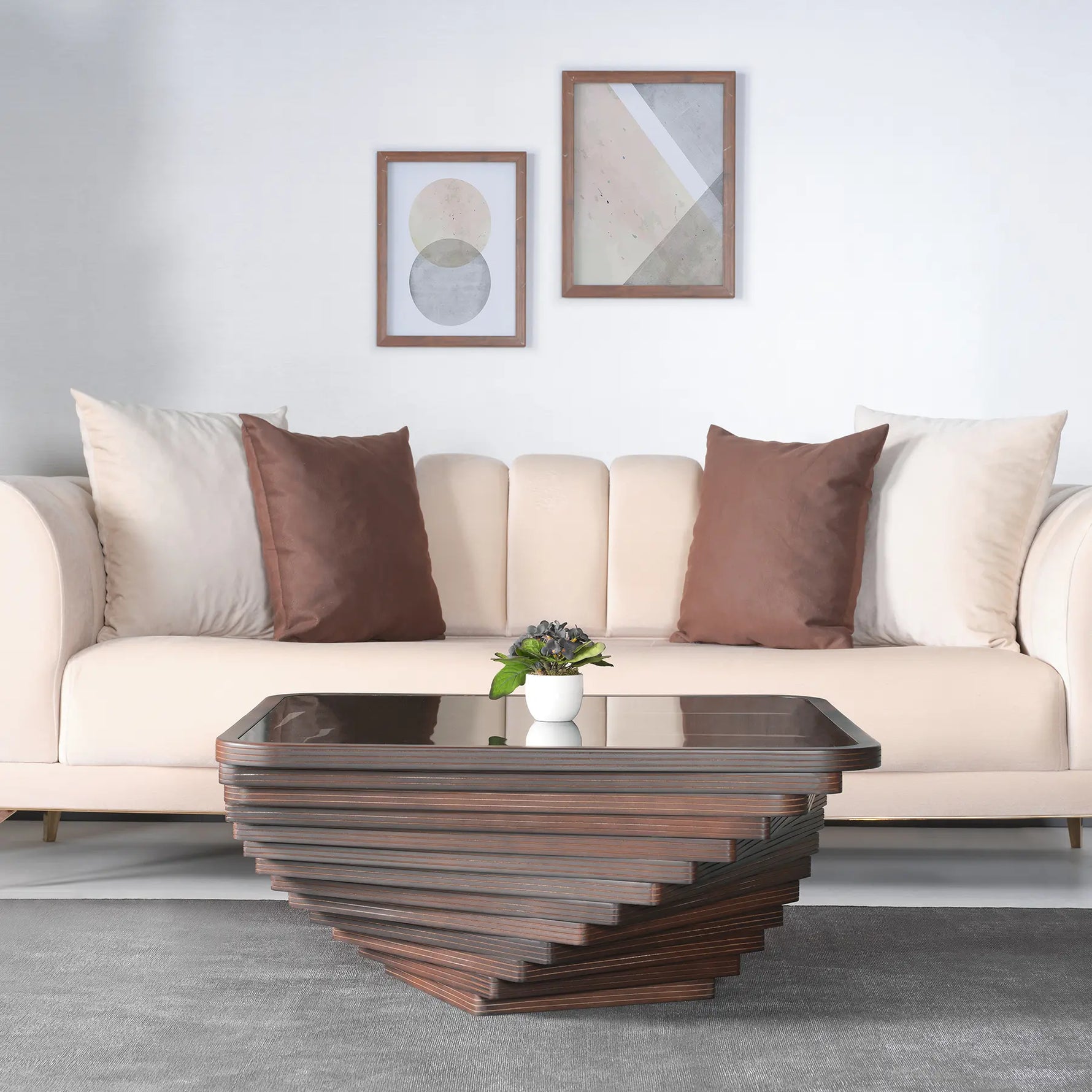 Modern living room with a beige sofa, brown and white pillows, and a wooden coffee table.