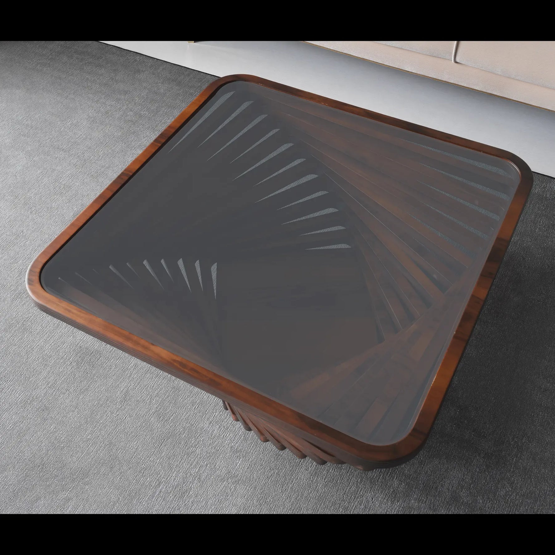 Glass coffee table with wooden frame on a gray floor