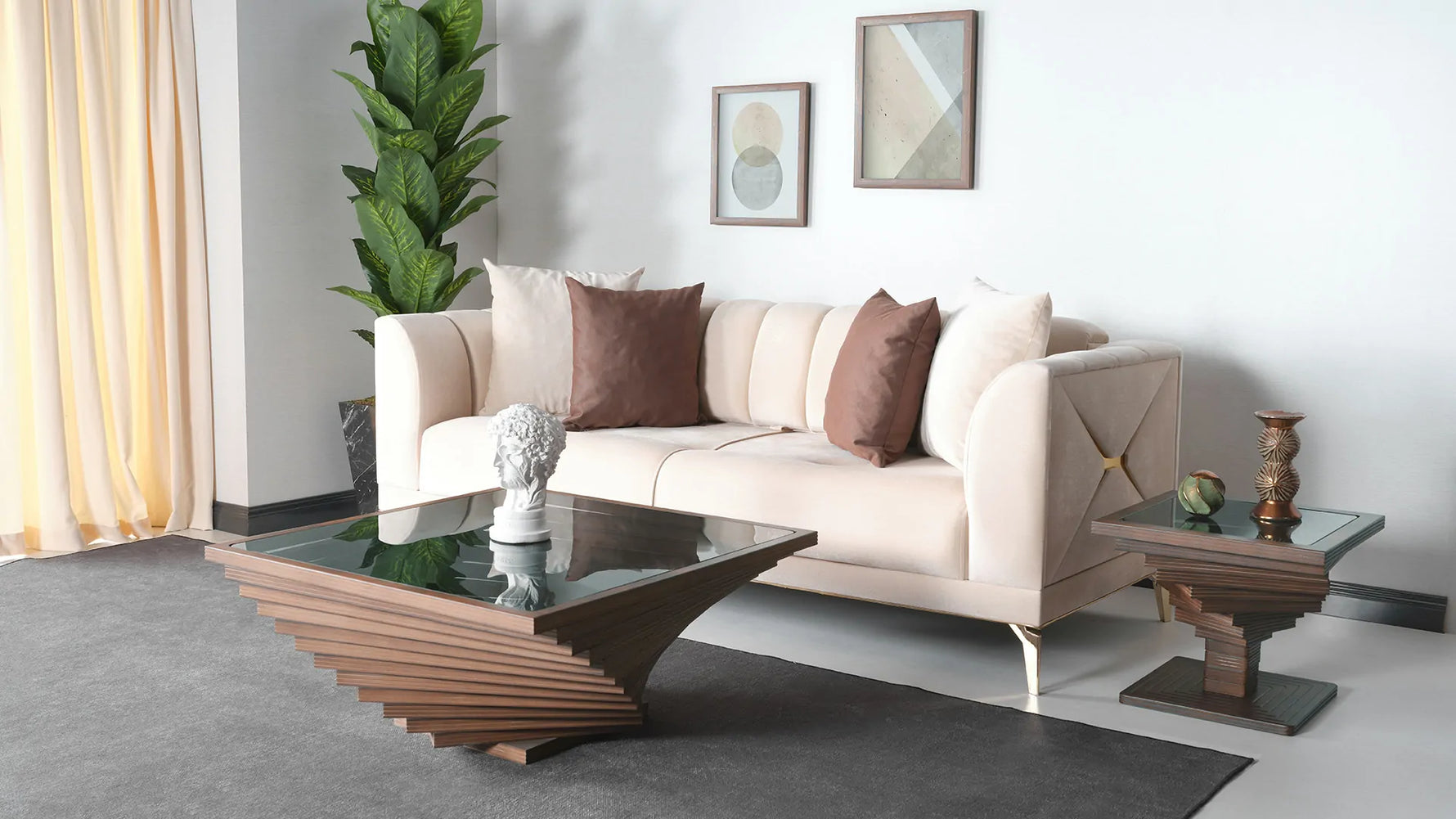 A square-shaped coffee table with a twisted design in the wood structure, featuring a dark glass top, placed on a tiled floor next to a beige sofa with a brown cushion.

